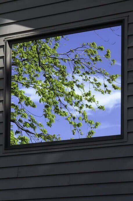 Bright reflection in exterior window of house in spring, southwestern Michigan