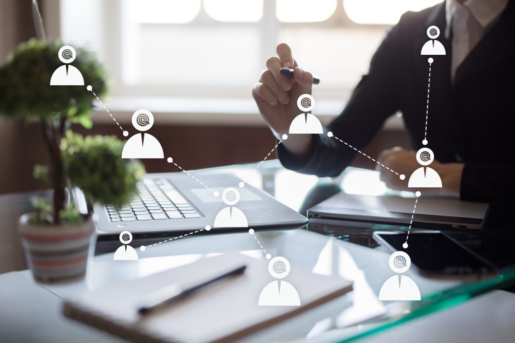 a marketer sits at a desk drawing conclusions to their target audience