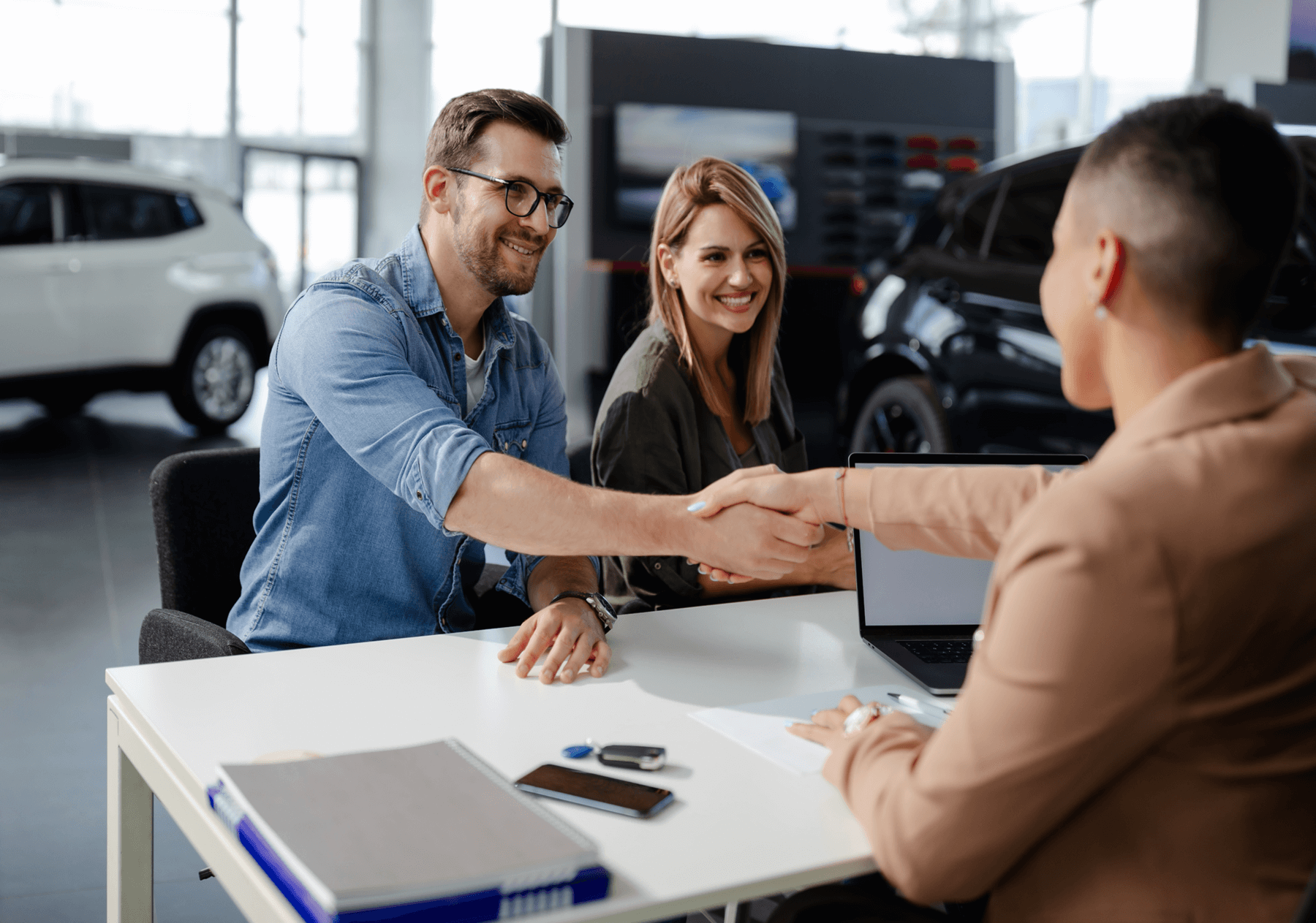 couple buying car at dealership