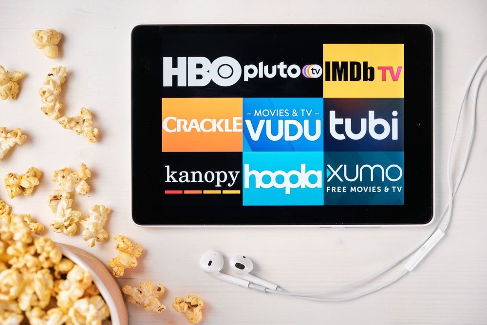A tablet with different FAST streaming apps on display, including Pluto TV, Xumo, VUDU, and Crackle
