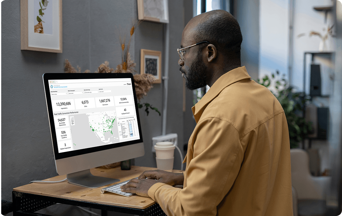 man looking at strategus reporting dashboard on desktop 