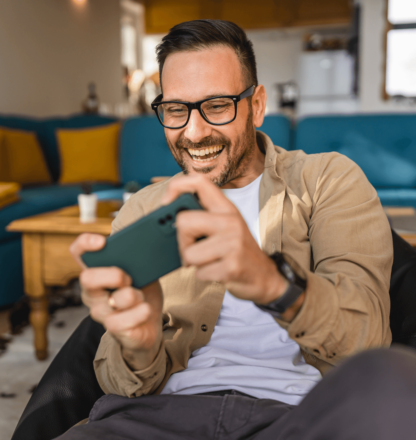 middle aged man playing video games on his smart phone