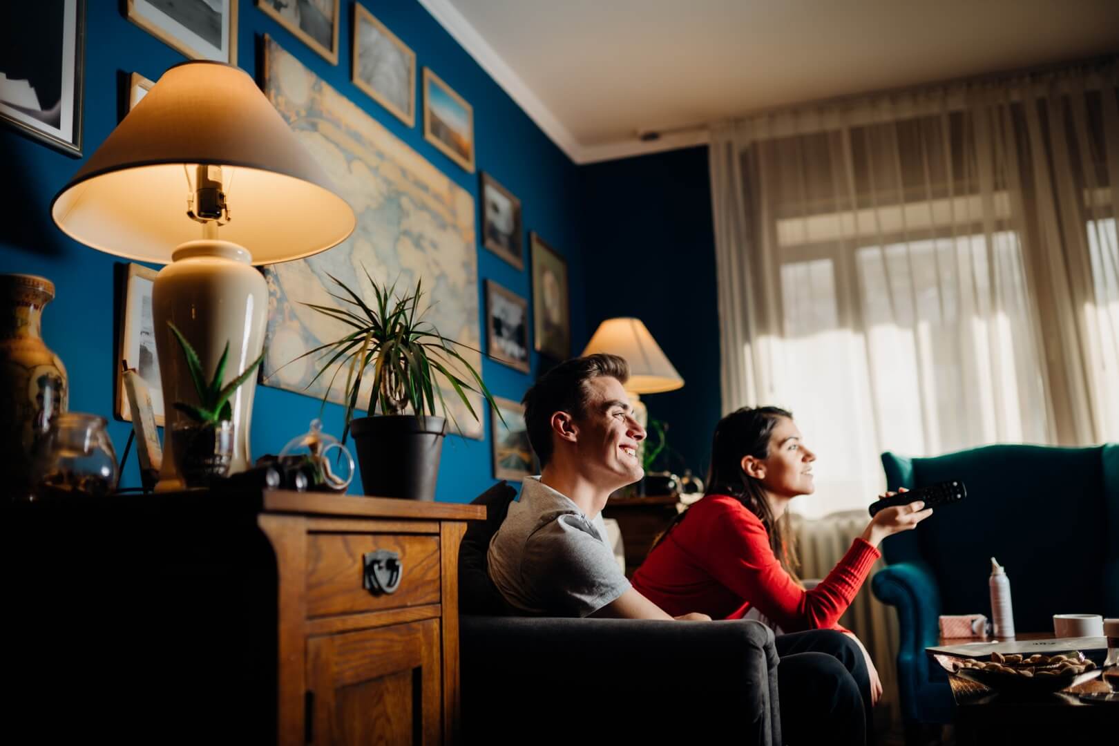 Man and woman watching TV on the living room couch